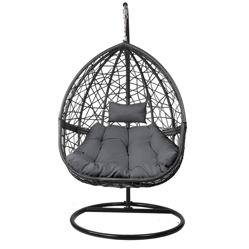 Black wicker hanging chair with gray cushions on a white background