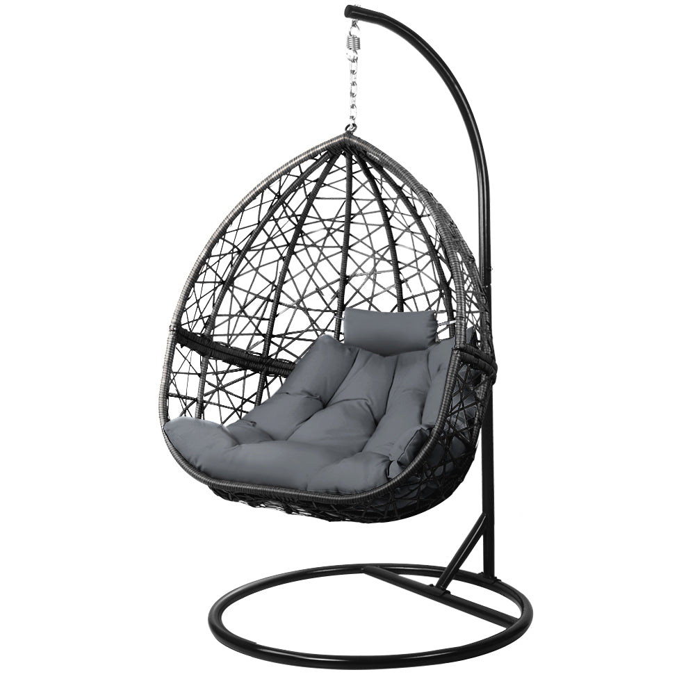 Hanging egg chair with black frame and gray cushions on a white background