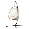 Hanging egg chair with white cushions on a black stand against a white background