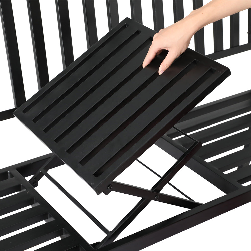 A close up of the foldable table being folded down in a black steel outdoor garden bench in a powder-coated finish and set on a white background.