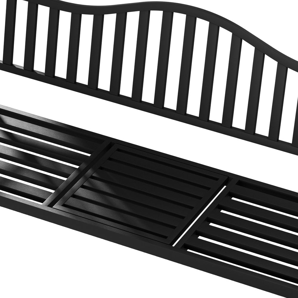 A close up of the foldable table being folded down so it's a bench seat in a black garden bench and set on a white background.