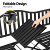 A close up of the foldable table being pulled up with an inset image of the safety clip lock in a black steel outdoor garden bench and set on a white background.