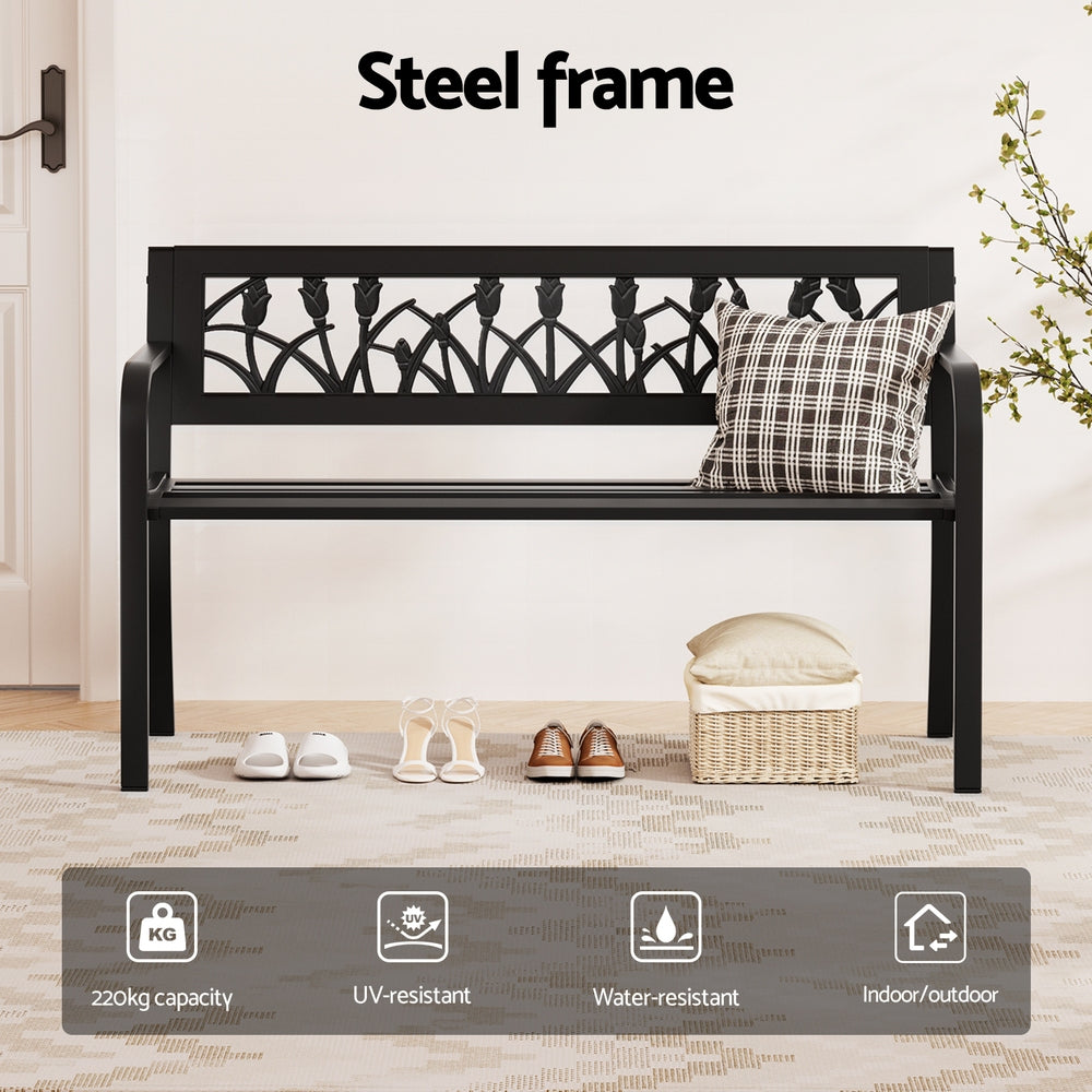 Black metal bench with decorative backrest and cushion on a wooden floor, featuring text 'Steel frame' and product features.