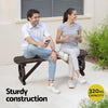 Two people sitting on a wooden bench with text about sturdy construction and capacity.