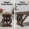 Wooden bench with wagon wheel design and extra support bars on a patio.