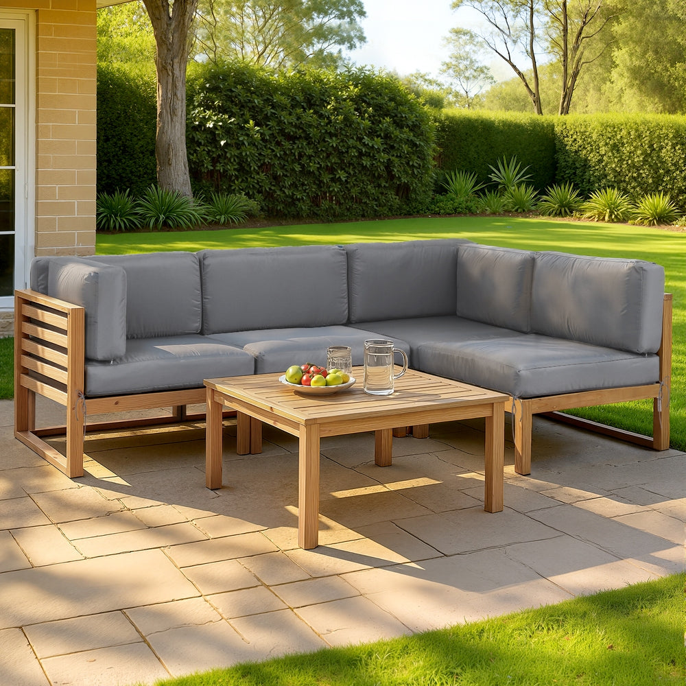Outdoor patio set with sectional sofa and coffee table on a paved patio.