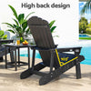 Black high-back chair on a patio with pool and garden view