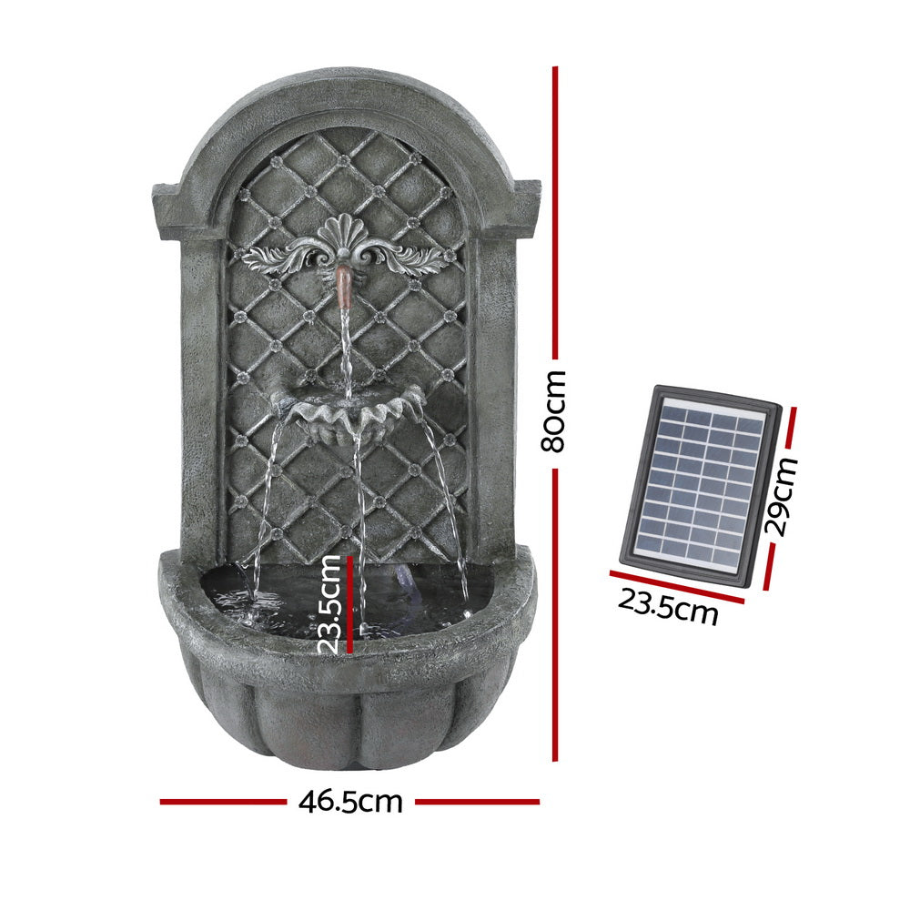 A grey Gardeon solar fountain with a classic cascading design, wall mounted, showing its dimensions and solar panel on a white background.