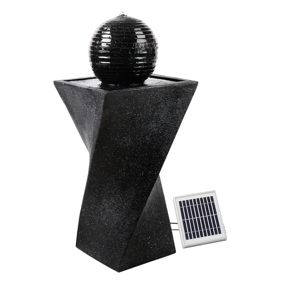 A black, twisted design solar-powered water fountain featuring a spherical solar panel on top and a ground holder. The fountain is made of polyresin with a weathered stone finish.