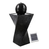 A black, twisted design solar-powered water fountain featuring a spherical solar panel on top and a ground holder. The fountain is made of polyresin with a weathered stone finish.