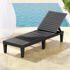 Black lounge chair by a pool