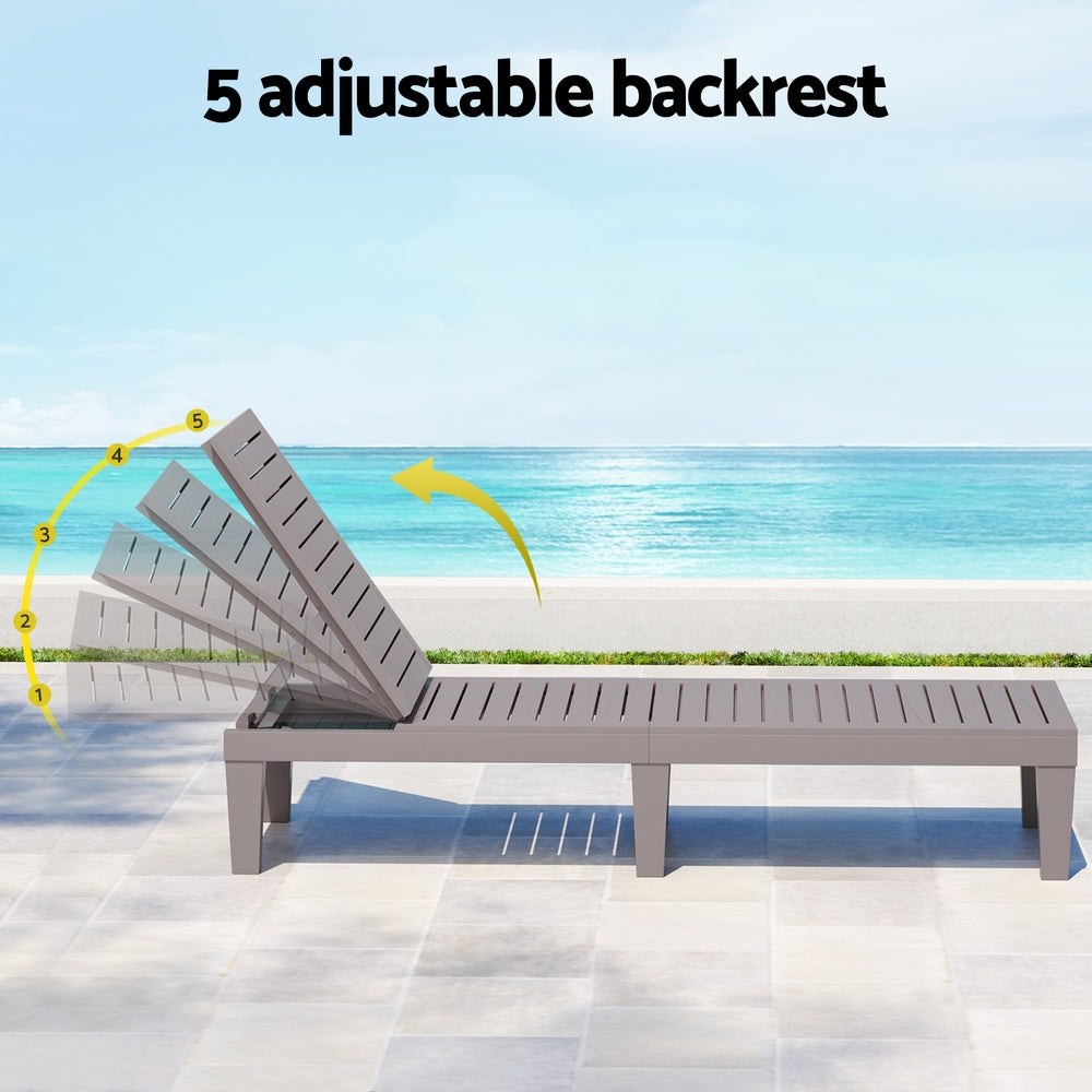 Gray lounge chair with adjustable backrest on a tiled floor with ocean view