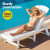 Woman relaxing on a white lounge chair by a pool with text about sturdy construction and capacity.