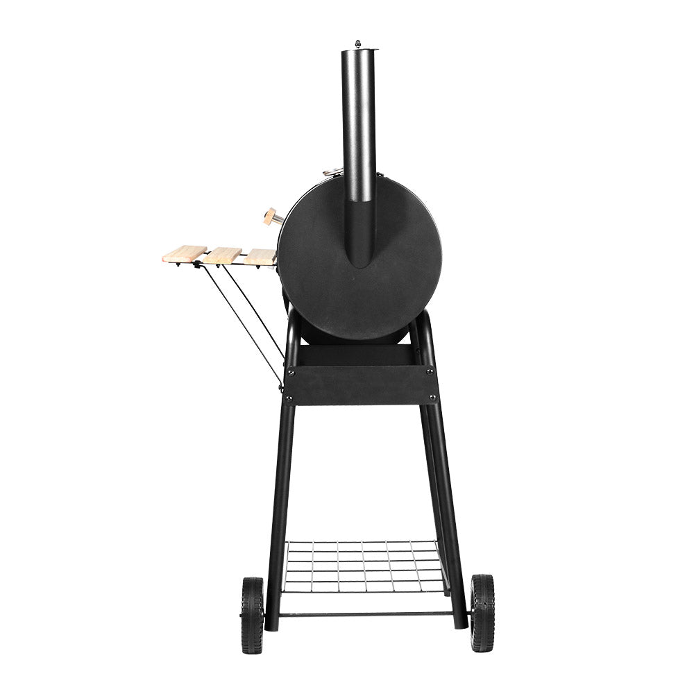 The back view of a black Grillz 2-in-1 offset charcoal smoker with a chrome-coated steel BBQ grill on top and a side firebox. It has a large front shelf, two wheels for mobility and is set on a white background.