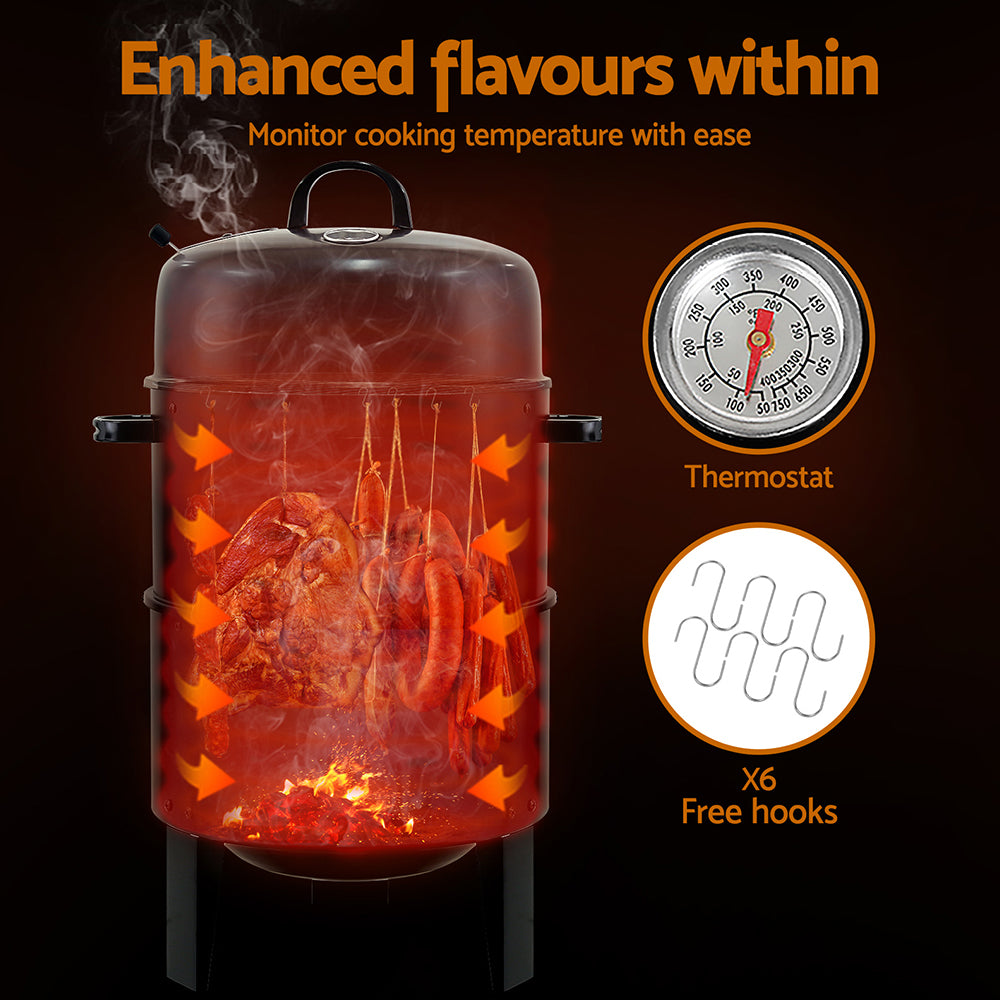The black 3-in-1 charcoal BBQ smoker with lid, showcasing meat and sausages hanging inside it and smoking, thermostat and 6 free hooks shown as inverted images; set on a dark background.