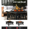 Black 2-in-1 use fire pit with a geometric pattern on the tabletop and a mesh dome on top in a patio setting with a fire burning. Two inset images below showcasing it being used as both a fire pit and a BBQ.