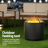 Outdoor heating tool on a grassy area with patio furniture and plants in the background.