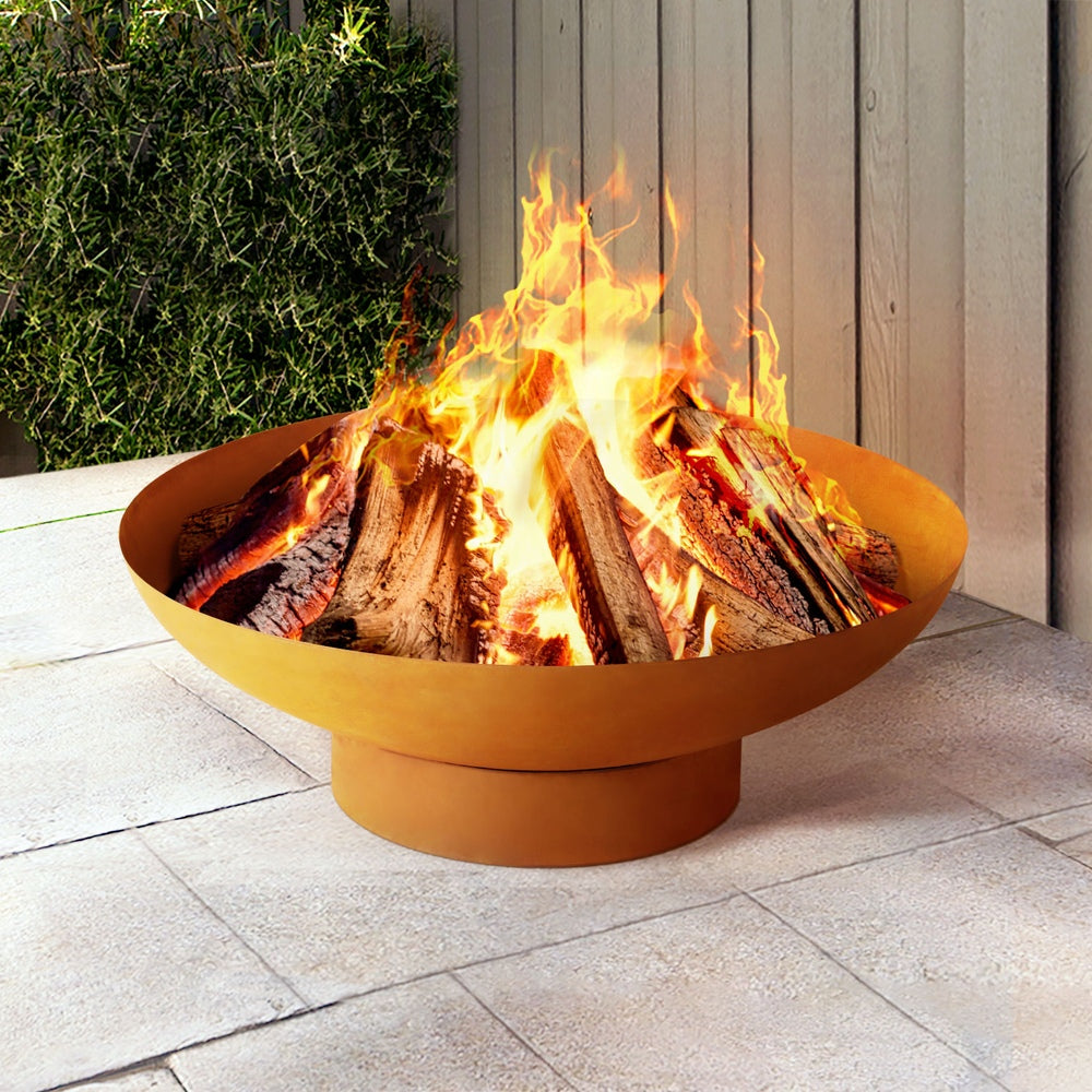 rust coloured fire pit with flames on a patio