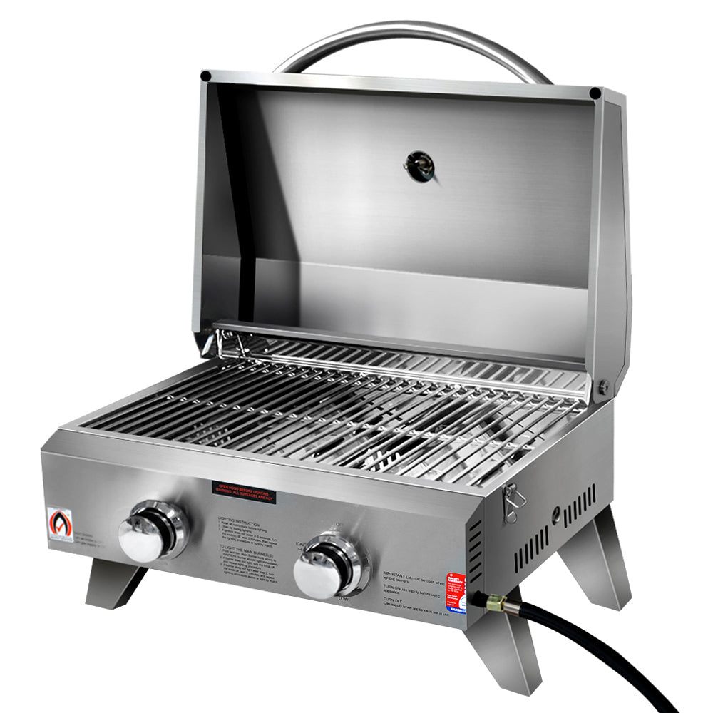 A portable stainless steel Grillz gas BBQ grill with two burners, open lid showing grates, set up on retractable legs with a carrying handle and on a white background.