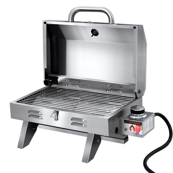 A portable stainless steel Grillz gas BBQ grill with an open lid, showing the front carry handle and the grill bars on a white background.