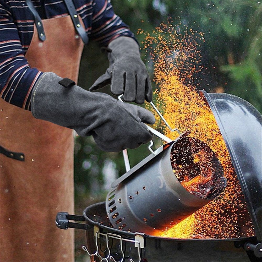 Person using a chimney starter for a barbecue with glowing embers
