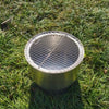 Inferno Smokeless Fire Pit with grill on green grass area.