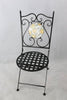 Black metal chair with decorative backrest on a light gray background