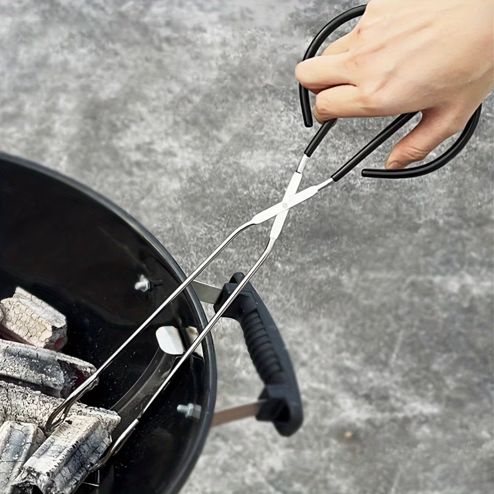 Person using tongs to handle charcoal in a grill