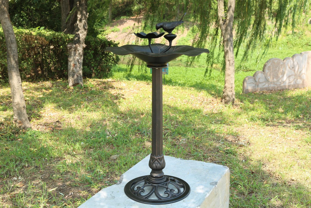 Decorative outdoor bird bath in a garden setting