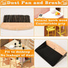 Dust pan and brush set with natural beech wood handle and black bristles, shown in use.