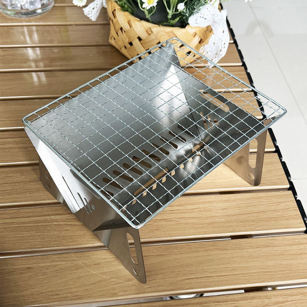 Metal grill on a wooden surface with a basket of flowers in the background