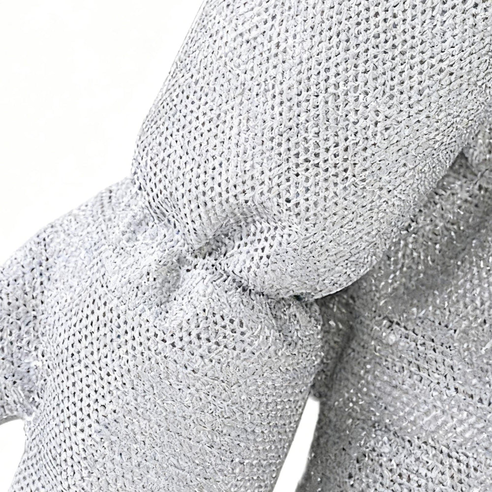 Close-up of textured gray fabric with a bow