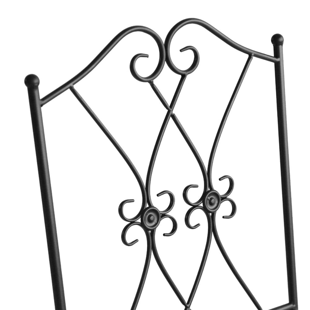 Decorative metal chair back with intricate designs on a white background