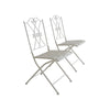 Two white metal chairs with decorative backrests on a white background