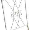 Close-up of a white metal decorative frame with intricate patterns on a white background