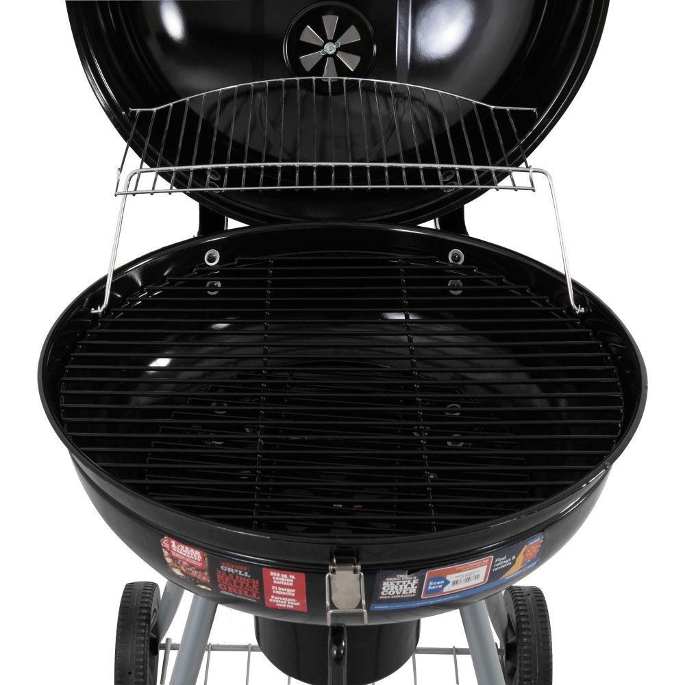 Close-up view of a portable charcoal BBQ smoker with an enameled firebowl and lid, in a tripod design. It has wheels and a storage shelf underneath, set on a white background.