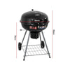 Portable charcoal BBQ smoker with an enameled firebowl and lid, in a tripod design. It has wheels and a storage shelf underneath, showing it's dimensions and set on a white background.