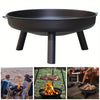 Black fire pit with legs on a white background, used for outdoor cooking and gatherings.
