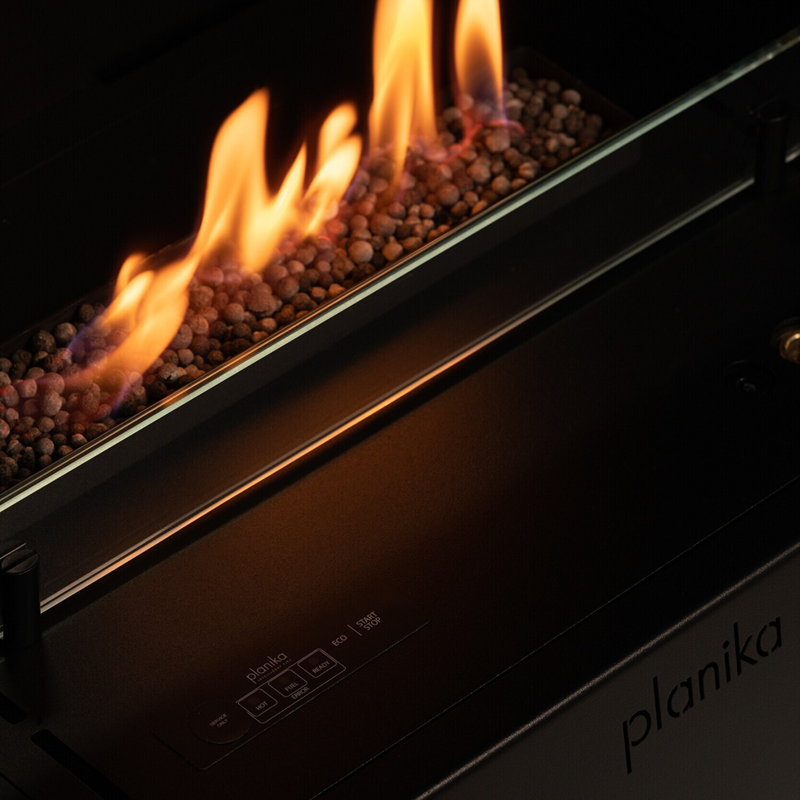 Planika gas fireplace with flames and control panel