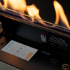 Planika ethanol burner with flames and digital display on a black background