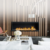 Modern living room with a fireplace, striped wall, and decorative items.