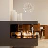 Modern fireplace with flames in a dining room setting