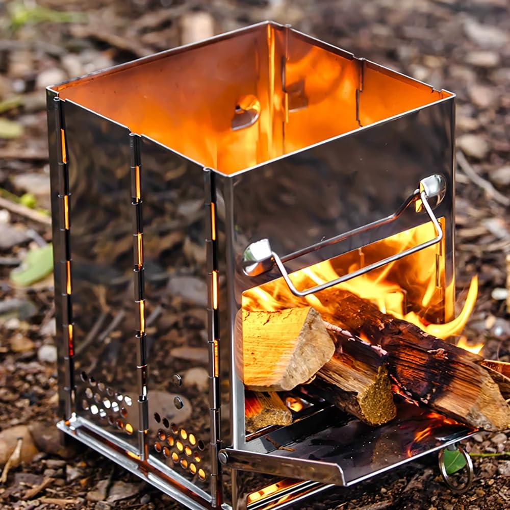 Portable metal stove with fire inside on a natural ground background