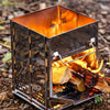 Portable metal stove with fire inside on a natural ground background