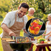 Man grilling vegetables using a rolling grill basket on a barbecue grill outdoors.