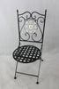 Decorative black metal chair with lattice seat and tiled backrest on a light gray background