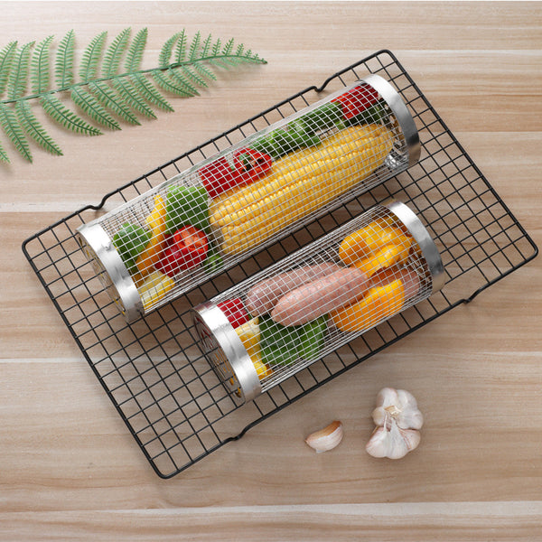 Two metal mesh vegetable grills with corn, bell peppers, and chicken on a wooden surface.