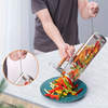 Person using a vegetable peeler to slice colorful bell peppers on a plate.