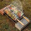 Metal mesh grill baskets with vegetables on a concrete block outdoors