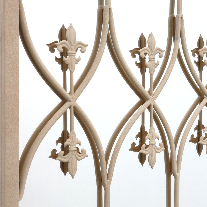 Decorative metal railing with floral designs on a white background